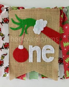 a burlap bag with the word one on it and a christmas ornament