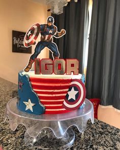 a birthday cake with captain america on top and the word's name is icing