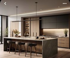 a modern kitchen with an island and bar stools