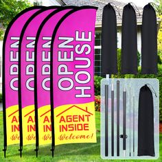 four pink and black flags with the words open house on them in front of a home