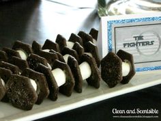 chocolate and marshmallows are arranged on a white plate next to a card