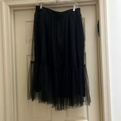 Black With Sheer Layer On Top. Great For Over Leggings Or Dressing Up With A Blazer. Size M Black Skirt With Elastic Waistband For Evening, Black Skirted Bottoms For Spring, Black Tulle Bottoms For Night Out, Black Tiered Tulle Skirt, Black Elastic Waistband Midi Skirt, Black Tiered Skirt For Spring, Casual Lined Skirt Bottoms For Evening, Chic Black Bottoms With Tulle Skirt, Orange Midi Skirt