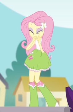 the pinkie is walking down the street in her green dress and boots, with an umbrella