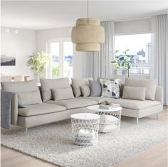 a living room filled with furniture and white walls