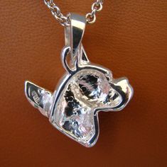 Please read. The following information should answer all your questions about this pendant. Breed-specific jewelry is a novel way to show off your favorite dog breed, it also makes a great present for the dog lovers on your gift list. In my many years of making and selling breed-specific jewelry I have heard more times that I can count that, it becomes the wearers favorite piece of jewelry. My pendants are made with a very high-quality solid sterling silver. I put a satin finish on all my breed Nugget-shaped Polished Jewelry As Gift, Sterling Silver Nugget Jewelry With Polished Finish, White Gold Jewelry With Shiny Finish For Gift, Angel Pendant, Gift List, A Novel, Dog Breed, Satin Finish, Belly Button Rings