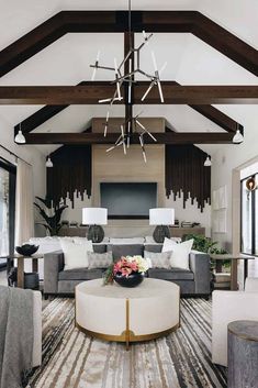 a living room filled with furniture and a flat screen tv mounted to the wall above it