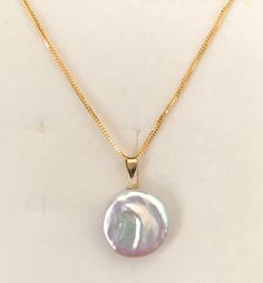 "Natural pinkish white coin pearl pendant with peoples chain necklace set , authentic Gold GOLD PURITY:- 916 GOLD chain 18k Gold coin pearl pendant Chain : 1mm peoples chain Pendant: natural pinkish white coin pearl pendant 16\" inches set Colour : YELLOW GOLD 16\" inches set👇🏽 * 916 gold chain 2.40 grams + 2.5cm 18k gold coin pearl pendant Hallmark: Hallmarked 916 stamp and 750 for 18k gold Hook: 's' hook Design : elegant white pinkish pearl pendant with people's chain necklace set * chain an Cheap Round Pearl Pendant Jewelry, Pearl Necklace With Coin Pendant As Gift, Gold Pearl Necklace With High Luster Round Pendant, Authentic Gold, Solid Gold Chains, Coin Pearls, Hook Design, Gold Coin, Colour Yellow