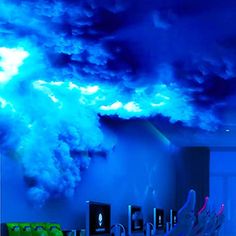 a room with blue lighting and clouds in the ceiling