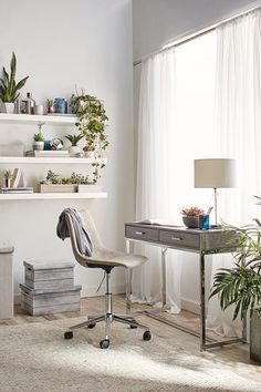 a room with a desk, chair and shelves filled with plants