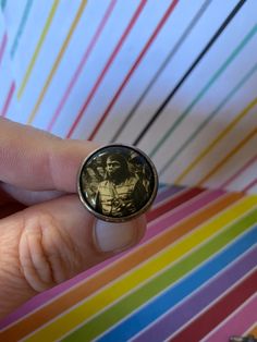 a person wearing a ring with an image on it