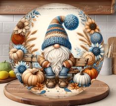 a plate with a painting of a gnome sitting on a bench surrounded by pumpkins and sunflowers