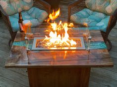 a fire pit sitting on top of a wooden table