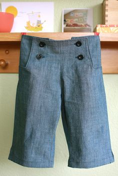 a pair of blue shorts hanging on a clothes line in a child's room