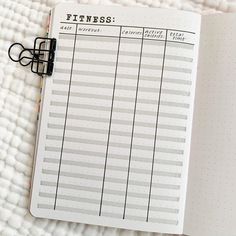 an open planner sitting on top of a bed