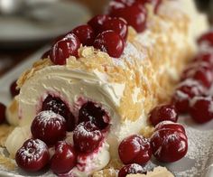 a piece of cake covered in whipped cream and cherries