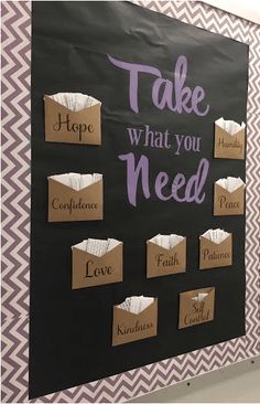 a bulletin board that says take what you need with some paper bags attached to it