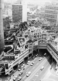 an aerial view of a city with tall buildings and lots of cars on the street