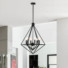 a chandelier hanging from the ceiling in a kitchen