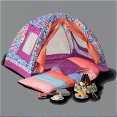 a tent with pillows and other items in it sitting on the ground next to each other