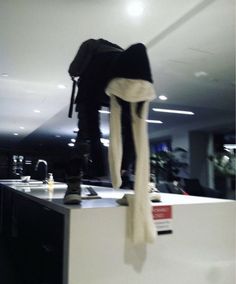 a person standing on top of a counter in a room with white walls and flooring