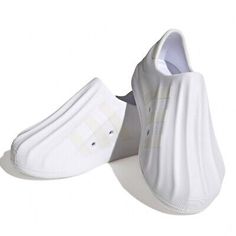 a pair of white tennis shoes sitting on top of each other