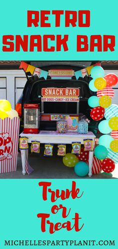 an image of a snack bar with balloons and streamers in the shape of popcorn buckets