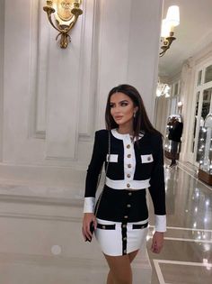 DESCRIPTION Bring out your Coco Chanel in this sophisticated set! The black and white blazer style crop and skirt features gold military buttons that are so timeless and chic. A perfect suit set for every working woman. Turn up to your next meeting with confidence and poise. Can be worn buttoned up or layered with a top for a casual look. FIT, MATERIAL & CAREStefania is 162cm/5'4 and wears a size XS/S90% Rayon, 9% Nylon, 1% Spandex Chic Chanel Outfit, Chanel Women Suit, Black Dress White Jacket, Chanel Look Outfit, Coco Chanel Outfits Classy, Coco Chanel Outfit Ideas, Black And White Chic Outfit, Coco Chanel Fashion Outfits, Coco Chanel Style Outfits