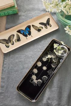 two trays with flowers and butterflies on them