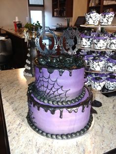 there is a purple cake with black decorations on it