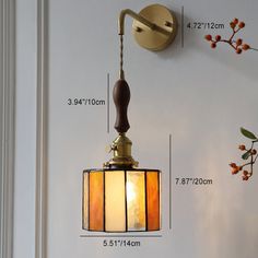 a wall mounted light fixture with measurements for the size and width, hanging on a white wall