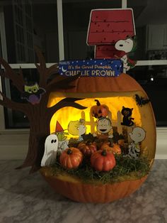 a pumpkin decorated with peanuts and charlie brown characters