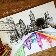 some colored pencils are laying on top of a piece of paper that is drawn