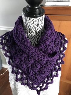 a purple crocheted scarf on top of a mannequin