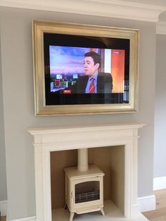 a television is mounted on the wall above a fireplace