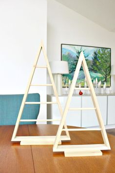 two wooden triangles sitting on top of a table next to a blue chair in a living room