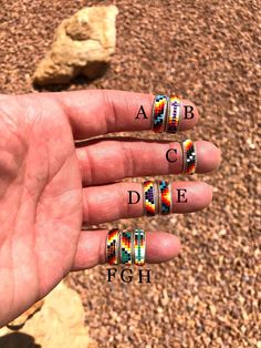 a person's hand with rings on it and the words abc, c, d e