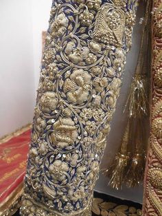 an elaborately designed blue and gold dress with sequins