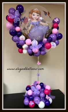 the balloon centerpiece is decorated with purple, pink and white balloons that spell out princesses