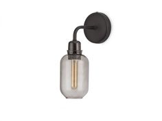 a wall mounted light with a glass bottle on the front and one light bulb attached to it