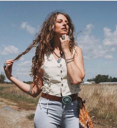 Join in the  Wild West revival of waistcoats with this unique Down Younder Jean Vest. Buttoning up past the bust, it can worn completely alone. The vest is loose fitting and features a v-neckline , adjustable lace up sides for that bygone vintage saloon feel, and four row buttons.  Pair it with high waist jeans for a full on rodeo outfit, with a full length maxi skirts for your vacation looks or pleated skirts for a little southern flare.   Styles with our "Stackhouse High Waist Jeans." Availabl Saloon Outfits, Spring Festival Outfit, Outfit With Vest, Vest And Jeans, White Waistcoat, Beach Tops Summer, Rodeo Outfit, Cinch Jeans, Outfit Western