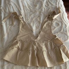 Brand New Never Worn. Petal & Pup Cream Colored, Low Cut, Very Flowery Top. The Ties At The Top Are Adjustable. It Is Very, Very Roomy. Cute Beige V-neck Top, Beige Ruffled Summer Tops, Cute Beige Summer Tops, Cute Beige Tops For Brunch, Beige Sleeveless Top With Tie Back, Beige Tie Back Tops For Beach, Beige Tie Back Tops For The Beach, Sleeveless Beige Top With Tie Back, Chic Beige Tops With Tie Back