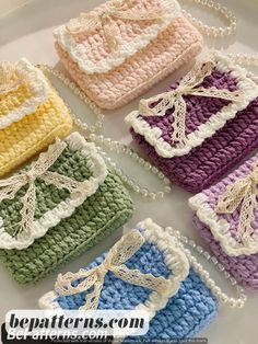 four crocheted purses with bows on them