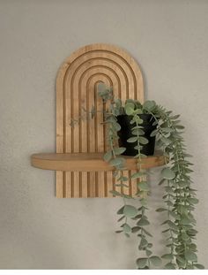 a potted plant sitting on top of a wooden shelf