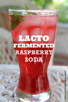 a tall glass filled with raspberry soda