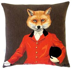 a red fox wearing a suit and holding a black hat on a brown pillow cover