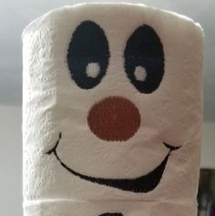 a close up of a toilet paper with a clown face on it's side