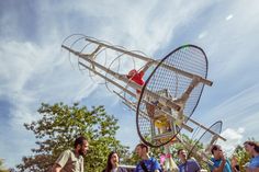 a group of people standing around a large metal object