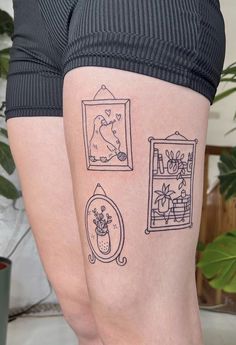 a woman's legs with tattoos on them, including an image of a mirror and flowers