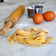 some food is laying out on the counter next to an egg roller and two eggs