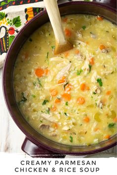 a pot filled with chicken and rice soup on top of a table next to a wooden spoon